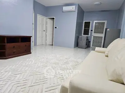 Spacious living room with modern furniture and air conditioning in a stylish apartment.