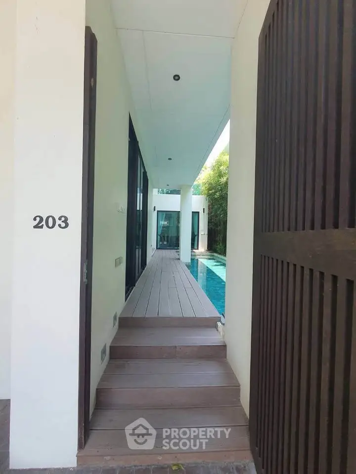 Modern villa entrance with private pool and sleek architectural design.