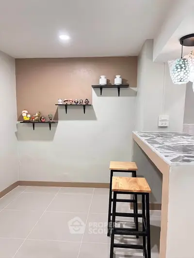 Modern kitchen with breakfast bar and stylish shelving in cozy apartment