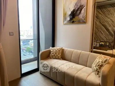 Stylish modern living room with plush sofa and city view balcony