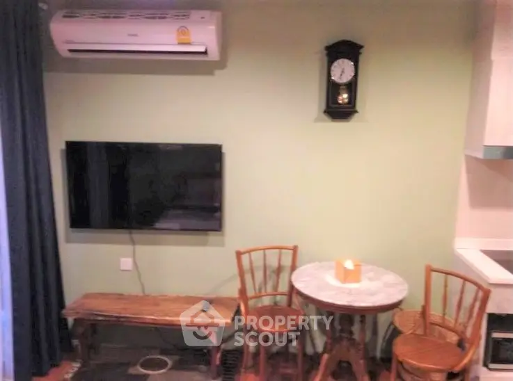 Cozy living room with wall-mounted TV and vintage clock