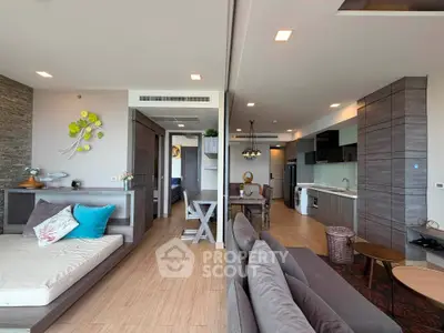 Spacious modern living room with open kitchen and stylish decor in a luxury apartment.