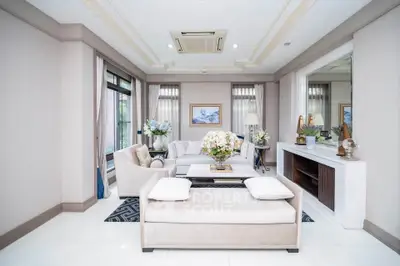 Luxurious living room with elegant decor and large windows offering natural light.