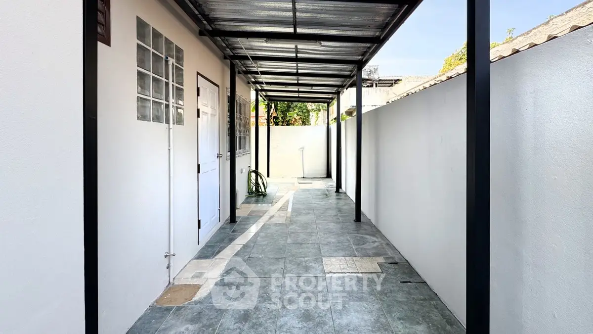 Spacious covered outdoor corridor with modern design and tiled flooring
