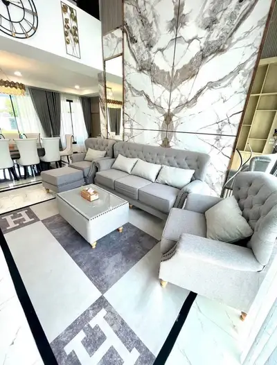 Luxurious modern living room with elegant gray furniture and marble accents, perfect for stylish living.
