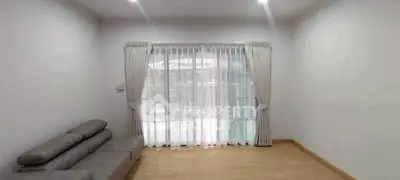 Spacious minimalist living room with large window and modern sofa