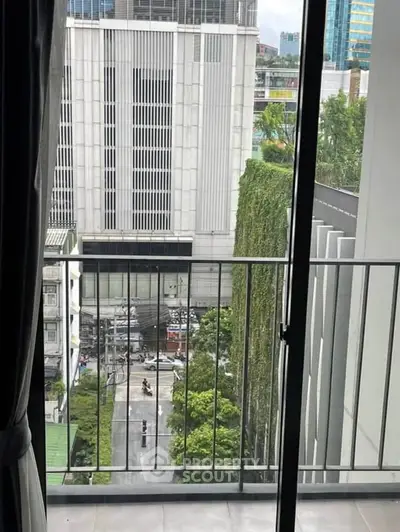 Urban balcony view with cityscape and greenery, perfect for modern living.