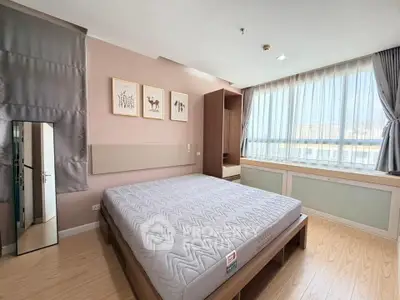 Spacious bedroom with large window and modern decor