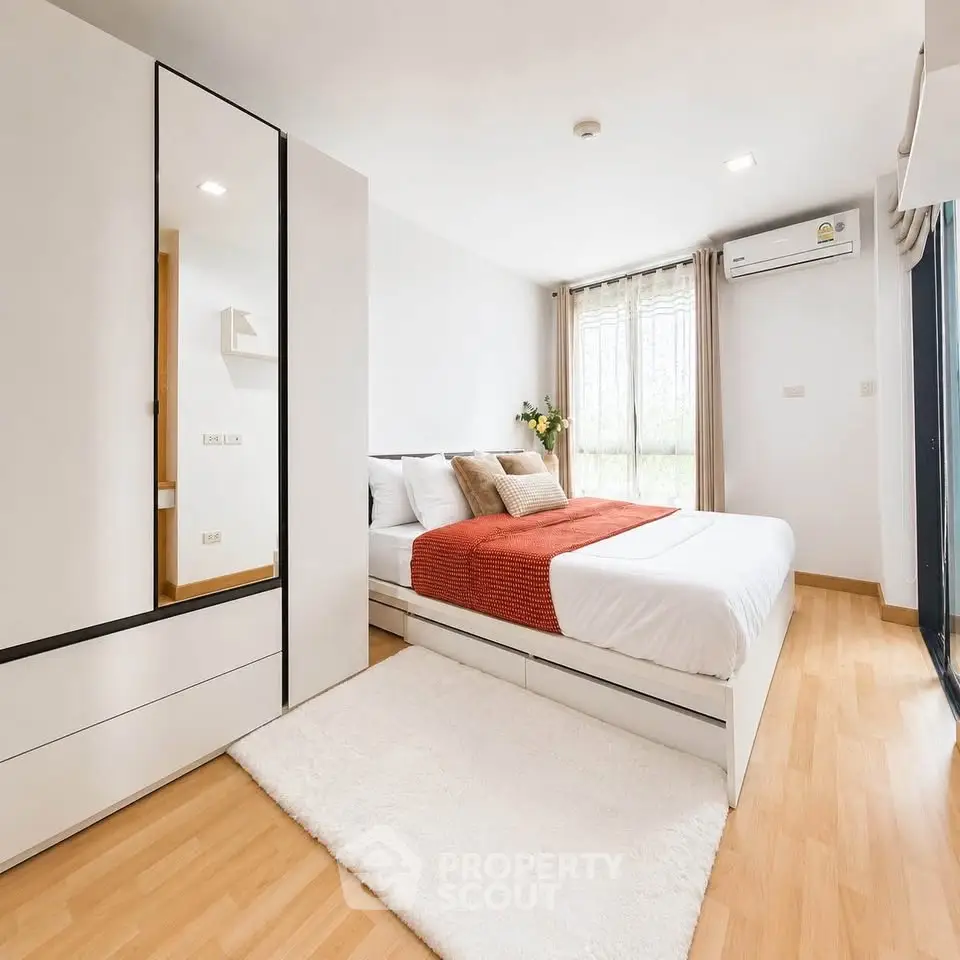 Spacious modern bedroom with stylish decor and natural light