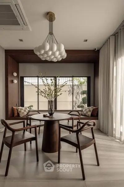 Elegant dining area with modern wooden chairs and stylish lighting, perfect for contemporary living.
