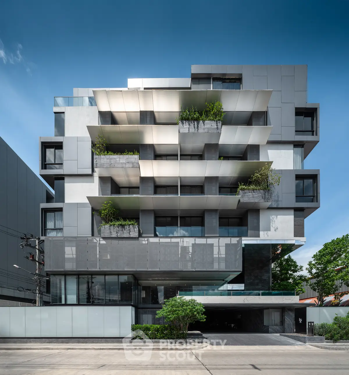 Modern architectural building with unique facade and lush greenery