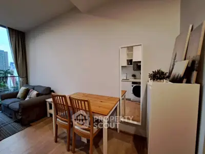 Modern living room with dining area and compact kitchen in urban apartment