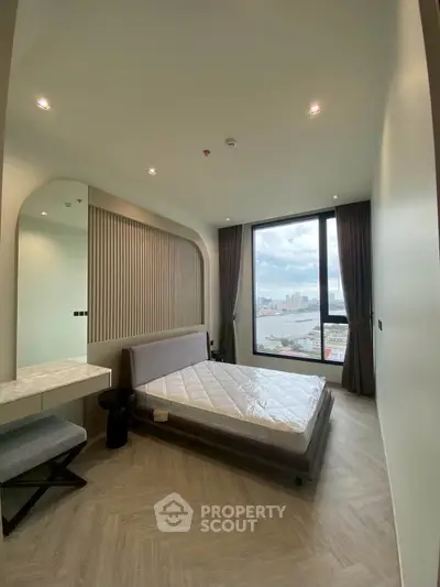 Modern bedroom with large window offering stunning city view, featuring sleek design and elegant furnishings.