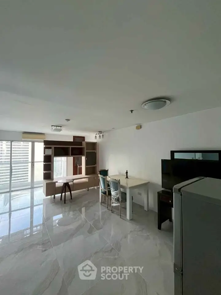 Spacious modern living room with sleek marble flooring and stylish furniture.