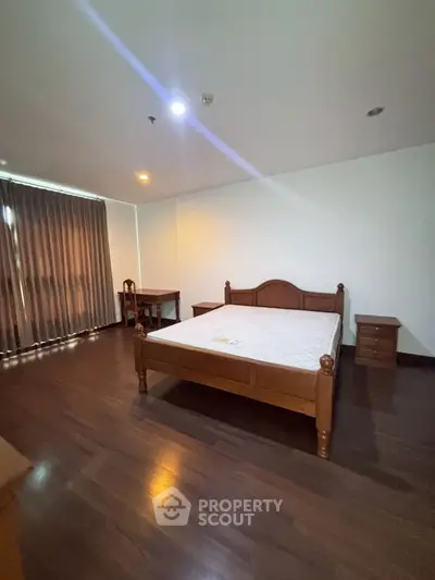 Modern bedroom with sleek design and wooden flooring