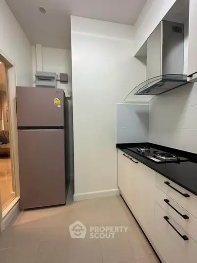 Modern kitchen with sleek cabinetry and gas stove in a compact layout