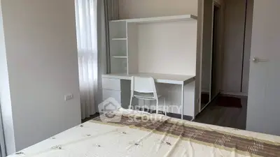 Modern bedroom with study desk and natural light, perfect for comfortable living.