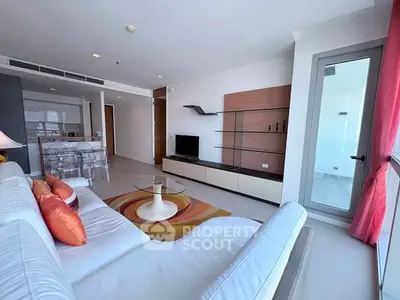 Spacious modern living room with stylish decor and open kitchen layout in a luxury apartment.