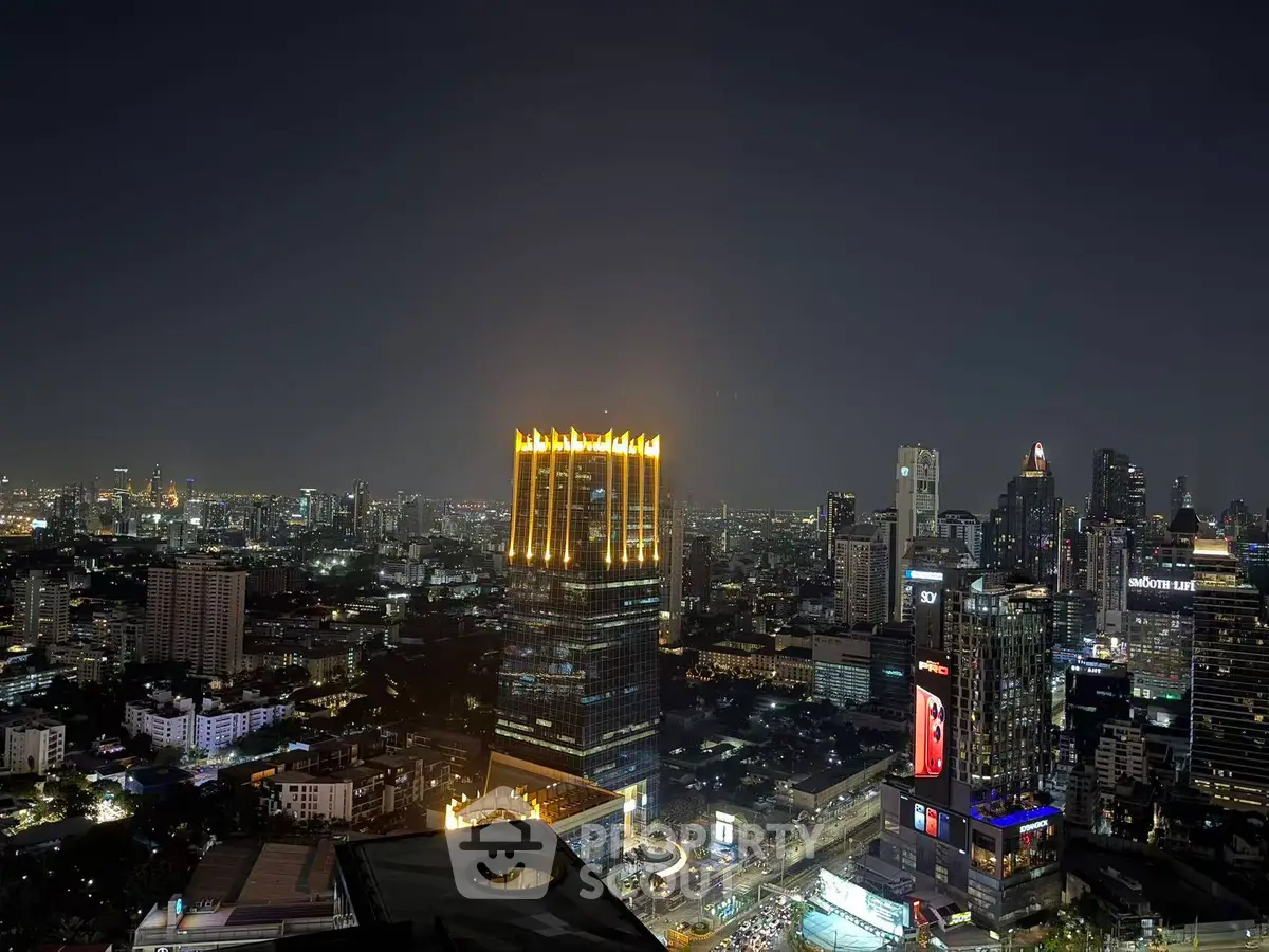 Stunning cityscape view of illuminated skyscrapers at night, showcasing vibrant urban living.