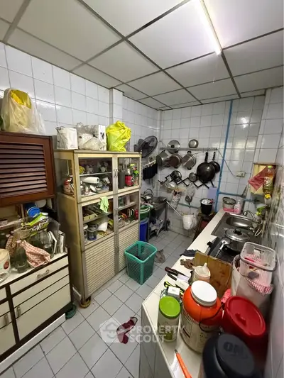 Cozy kitchen with ample storage and tiled walls, perfect for culinary enthusiasts.
