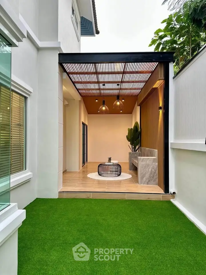 Stylish modern outdoor patio with green lawn and wooden accents