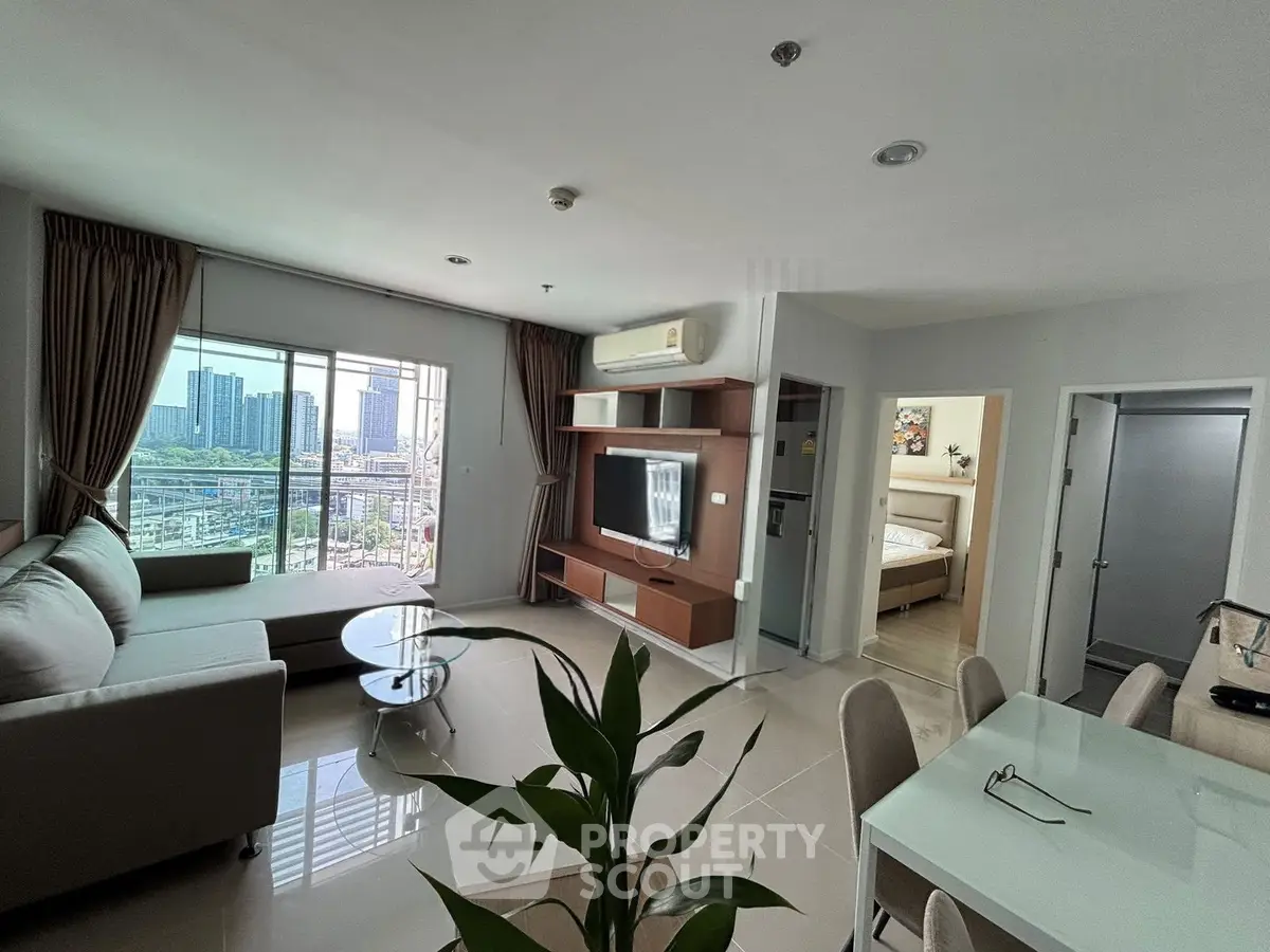 Spacious modern living room with city view, open layout, and elegant furnishings in a high-rise apartment.