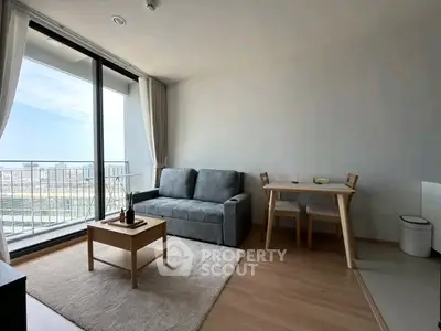Modern living room with large window and balcony view, featuring cozy sofa and dining area.