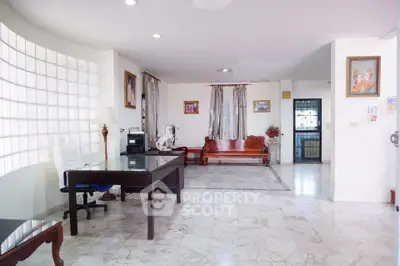 Spacious living room with marble flooring and elegant furniture