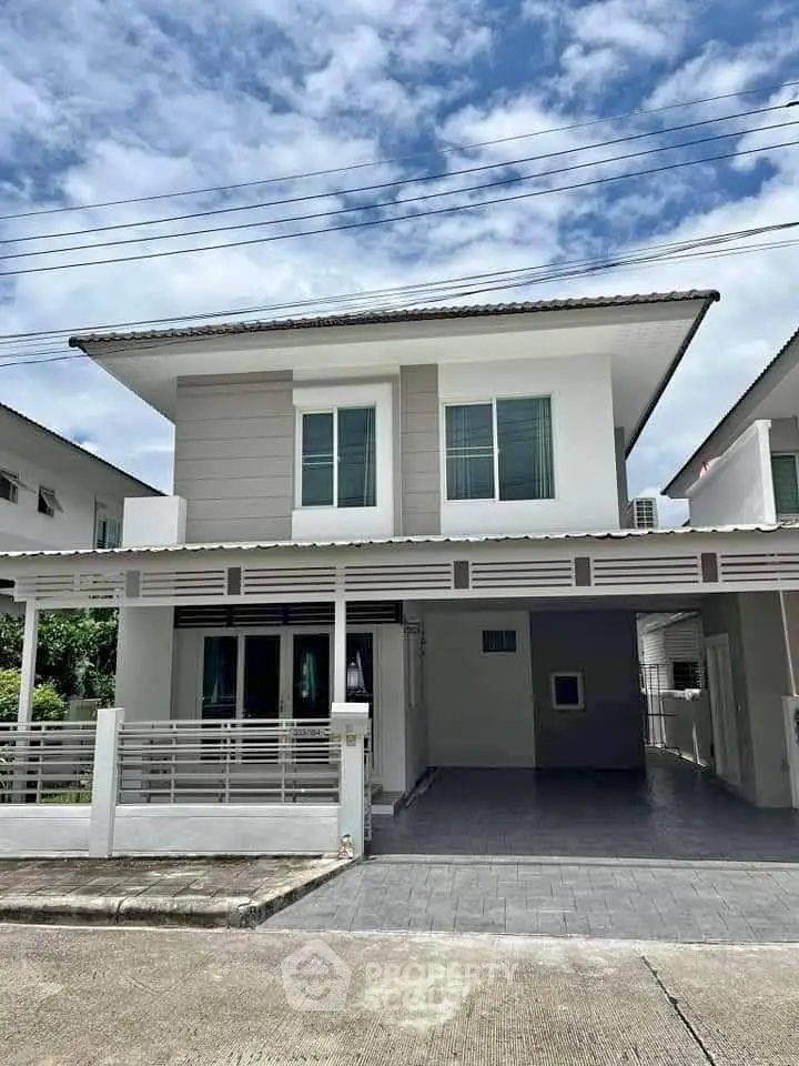 Modern two-story house with spacious driveway and contemporary design