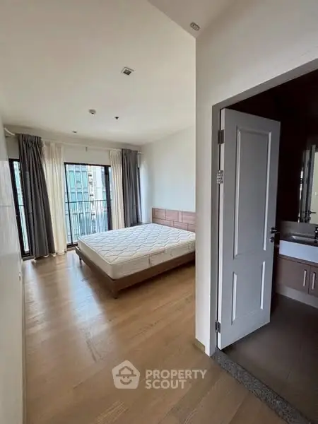 Spacious bedroom with large windows and modern decor