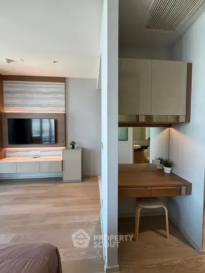 Modern bedroom with built-in TV unit and stylish study nook