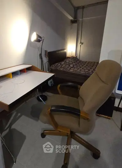 Cozy bedroom with study area featuring a comfortable chair and desk, perfect for work and relaxation.