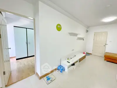 Spacious living area with modern minimalist design and ample natural light.