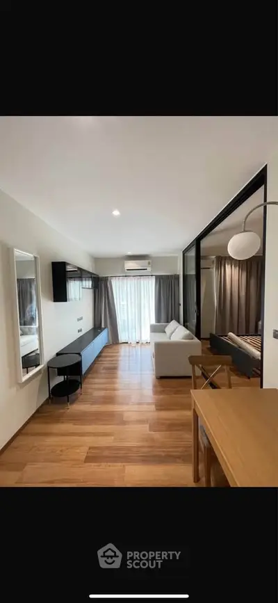 Modern living room with wooden flooring and stylish furniture