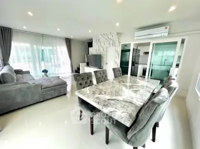 Luxurious modern living room with marble dining table and plush gray sofas