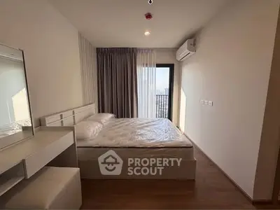 Modern bedroom with balcony view, featuring sleek design and natural light.