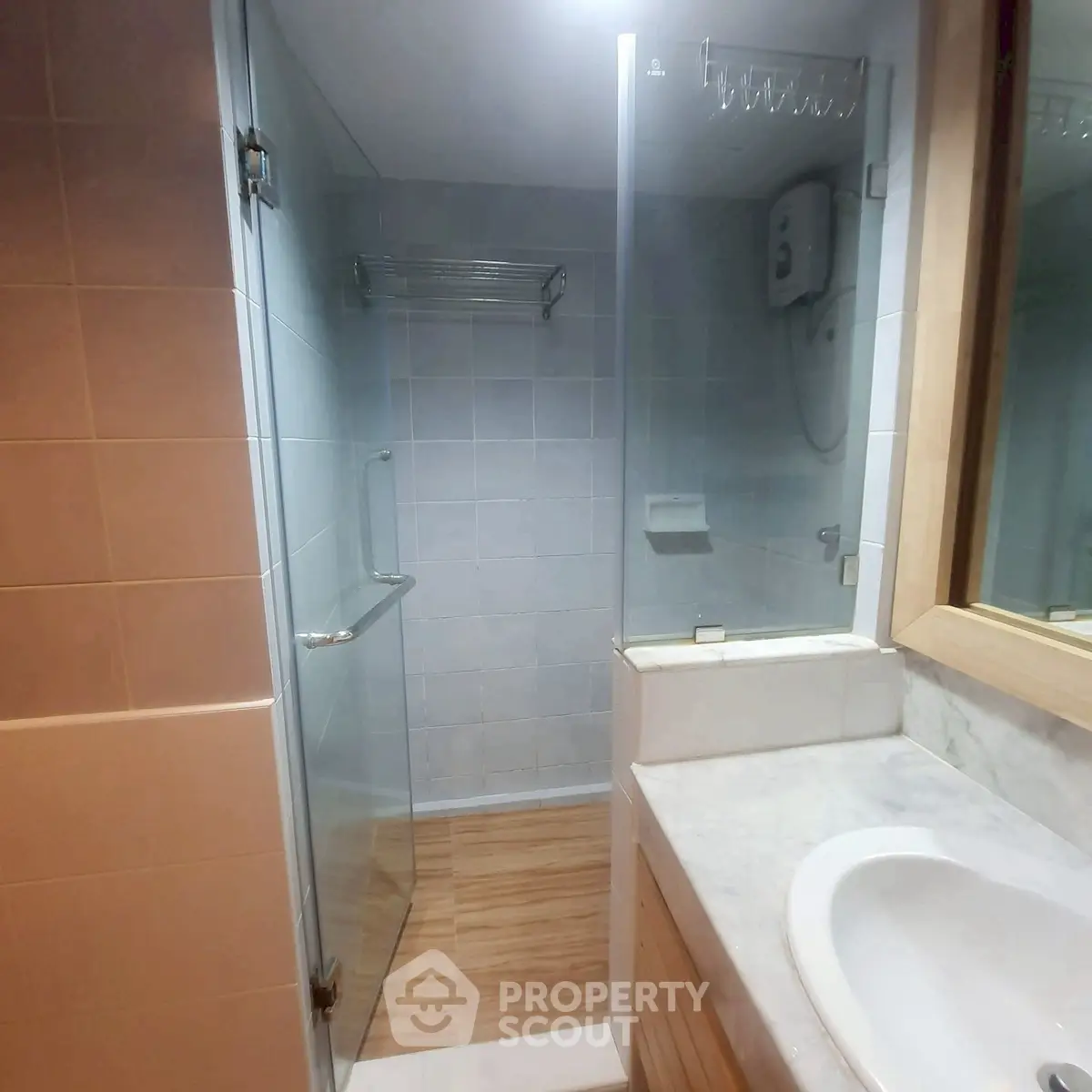 Modern bathroom with glass shower and marble sink countertop