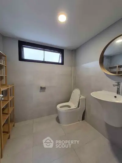 Modern minimalist bathroom with sleek fixtures and natural light
