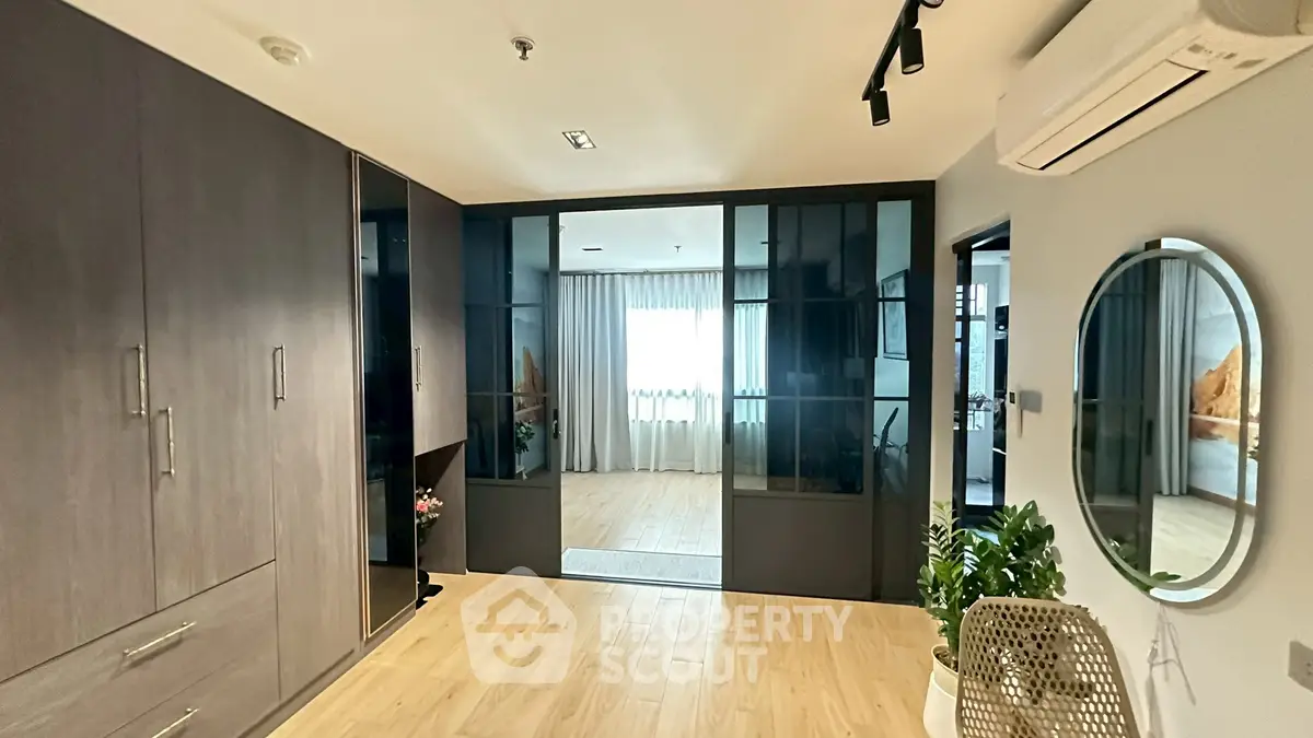 Modern interior with wooden flooring, glass partitions, and stylish decor