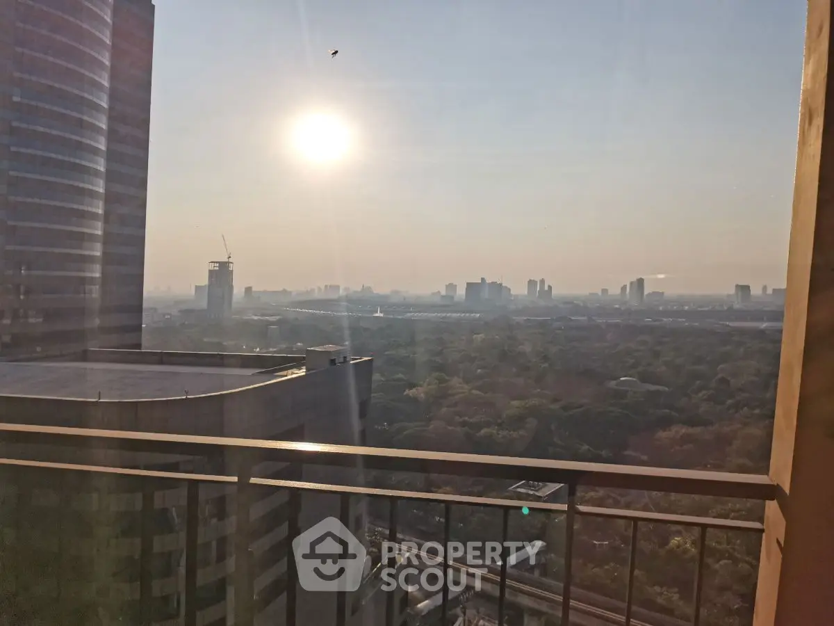 Stunning cityscape view from a high-rise balcony at sunset, perfect for urban living.