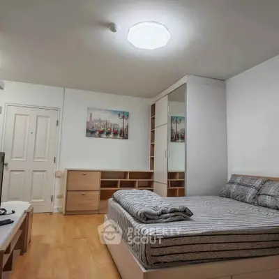 Modern bedroom with stylish furniture and cozy ambiance, featuring a comfortable bed and ample storage space.