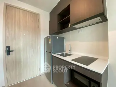 Modern compact kitchen with sleek cabinetry and built-in appliances