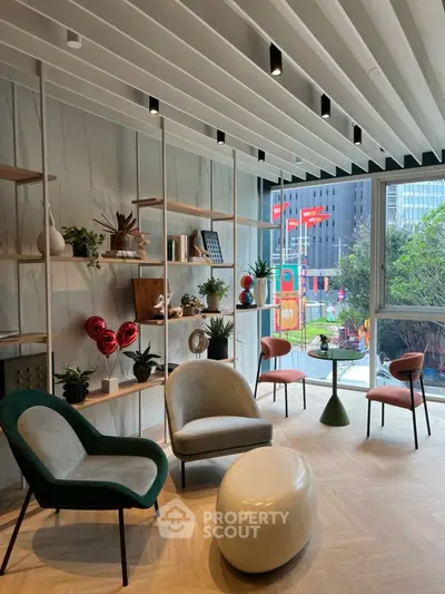 Modern living room with stylish furniture and city view, featuring elegant decor and natural light.