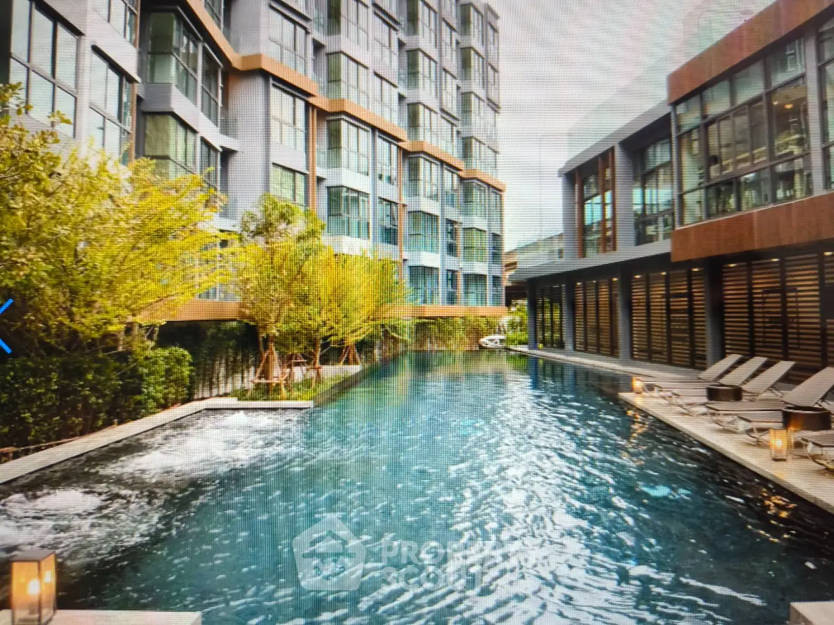 Luxurious modern apartment complex with stunning outdoor pool and lush greenery
