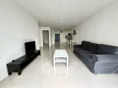 Spacious modern living room with sleek furniture and minimalist design.