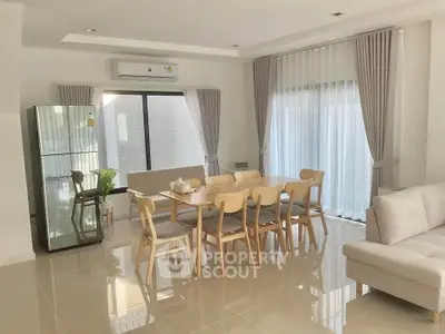Spacious modern dining area with elegant furniture and natural light