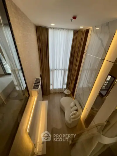 Luxurious high-ceiling living room with modern decor and elegant lighting