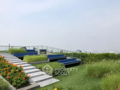 Stunning rooftop garden with modern seating and panoramic city views, perfect for relaxation and gatherings.