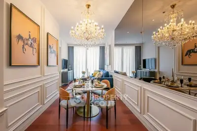 Luxurious dining area with elegant chandeliers and stylish decor in a modern apartment.