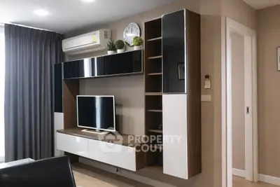 Modern living room with sleek entertainment unit and air conditioning